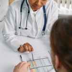 a medical practitioner showing a patient paper